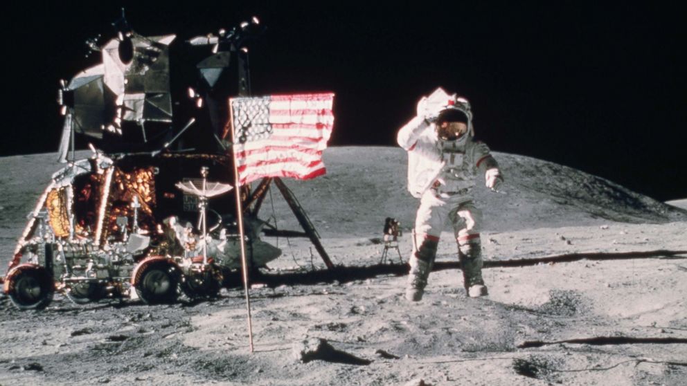 John W. Young, Commander of Apollo 16 moon mission, salutes the United States flag as he leaps from the lunar surface near the lunar lander in this undated file photo.