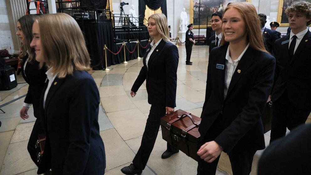 PHOTO: Senate pages carry Electoral College ballot boxes to the House Chamber for of a joint session of Congress to certify the results of the 2024 Presidential election at the Capitol, Jan. 6, 2025, in Washington.