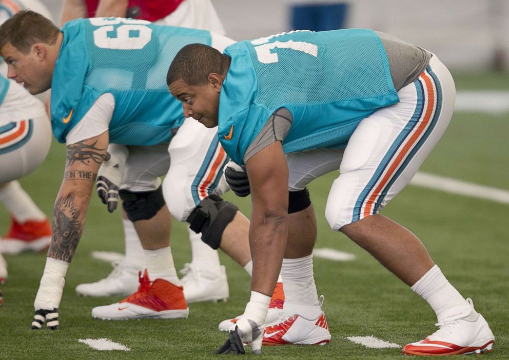 PHOTO: Tackle Jonathan Martin, right, in his stance before the ball is snapped during Miami Dolphins practice. 
