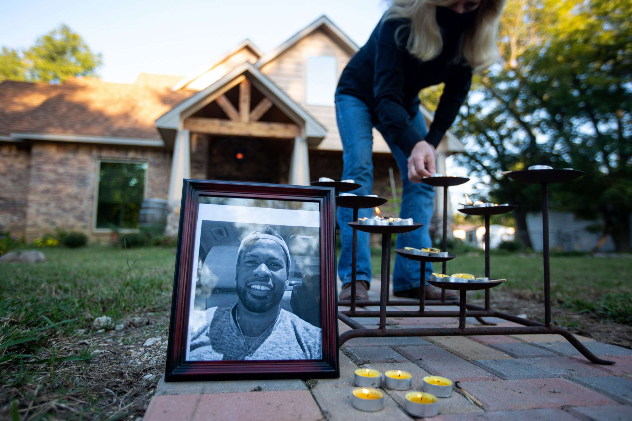 PHOTO: A portrait of Jonathan Price sits next to candles during a vigil in Wolfe City, Texas, Oct. 5, 2020. 