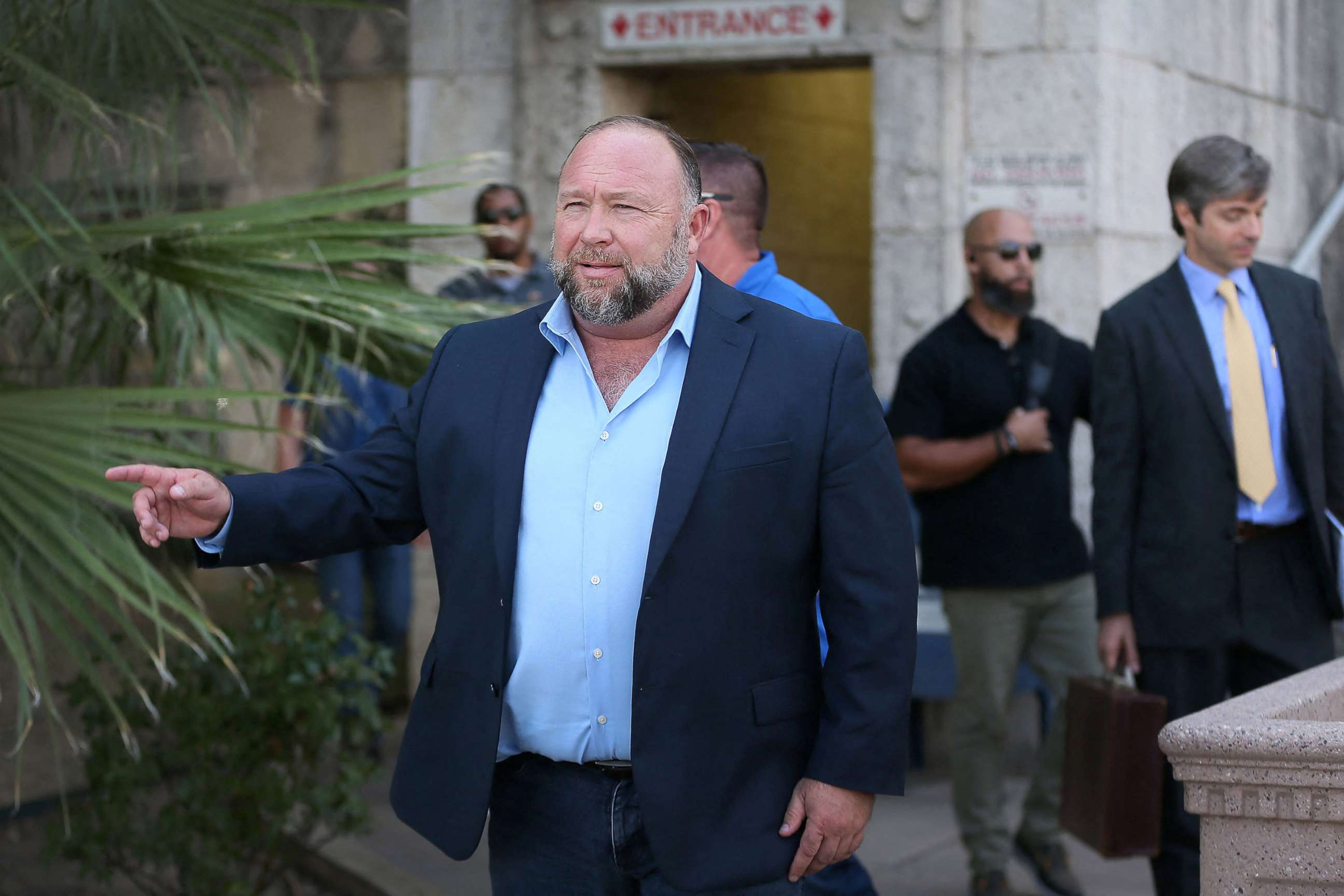 PHOTO: Alex Jones steps outside of the Travis County Courthouse, to do interviews with media after he was questioned under oath about text messages and emails by lawyer Mark Bankston, in Austin, Texas, Aug. 3, 2022. 
