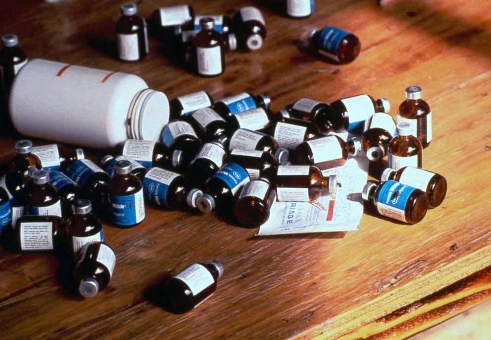 PHOTO: Bottles of poison belonging to members of the Peoples Temple cult, who participated in a mass suicide by ingesting or consuming a cyanide-laced drink, are seen on a table in Jonestown, Guyana, 1978.