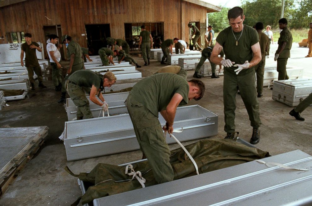 PHOTO: U.S. military personnel place bodies in coffins at the airport in Georgetown, Guyana, after over 900 members of the Peoples Temple committed suicide in Jonestown, Guyana in Nov. 1978.