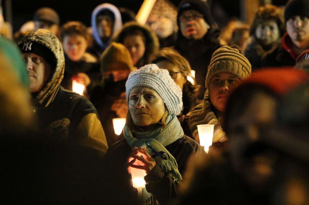 PHOTO: People hold candles at a vigil for Jersey City Detective Joseph Seals outside Queen of Peace Church in North Arlington, N.J., Dec. 15, 2019.