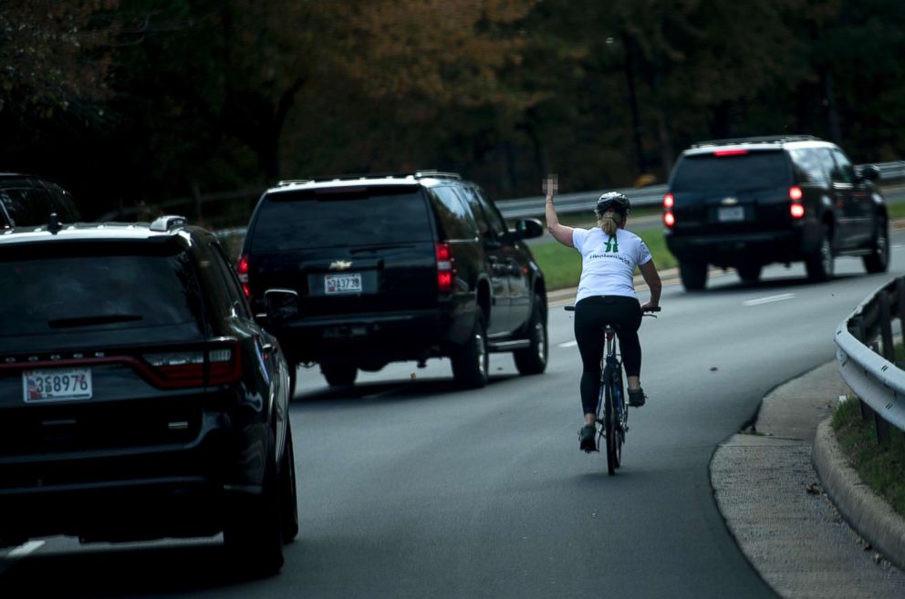 PHOTO: Juli Briskman gestures with her middle finger as a motorcade with President Donald Trump departs Trump National Golf Course, Oct. 28, 2017 in Sterling, Va.