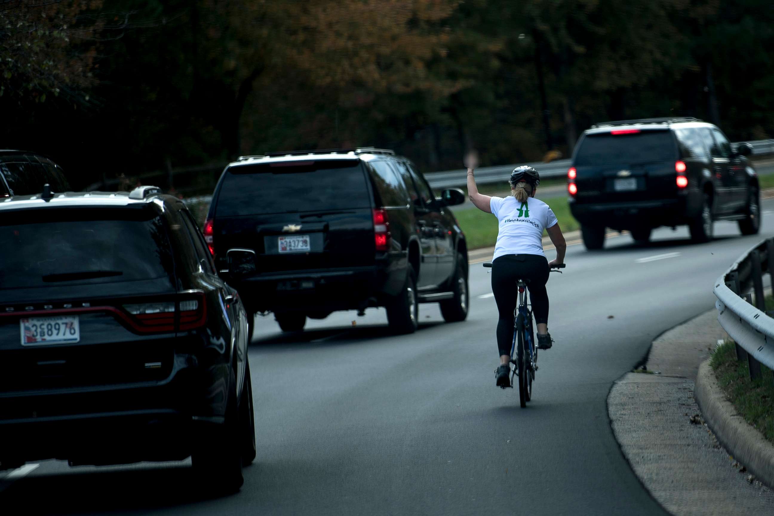 PHOTO: Juli Briskman gestures with her middle finger as a motorcade with President Donald Trump departs Trump National Golf Course on Oct. 28, 2017, in Sterling, Va.