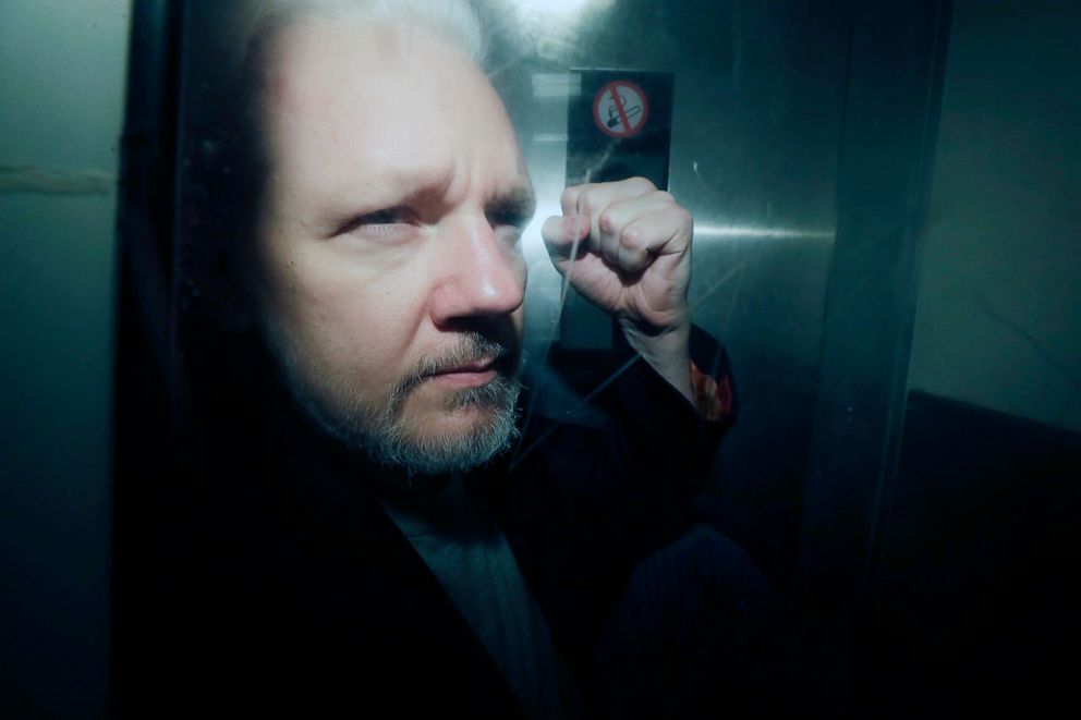 PHOTO: In this May 1, 2019, file photo, WikiLeaks founder Julian Assange puts his fist up as he is taken from court in London.