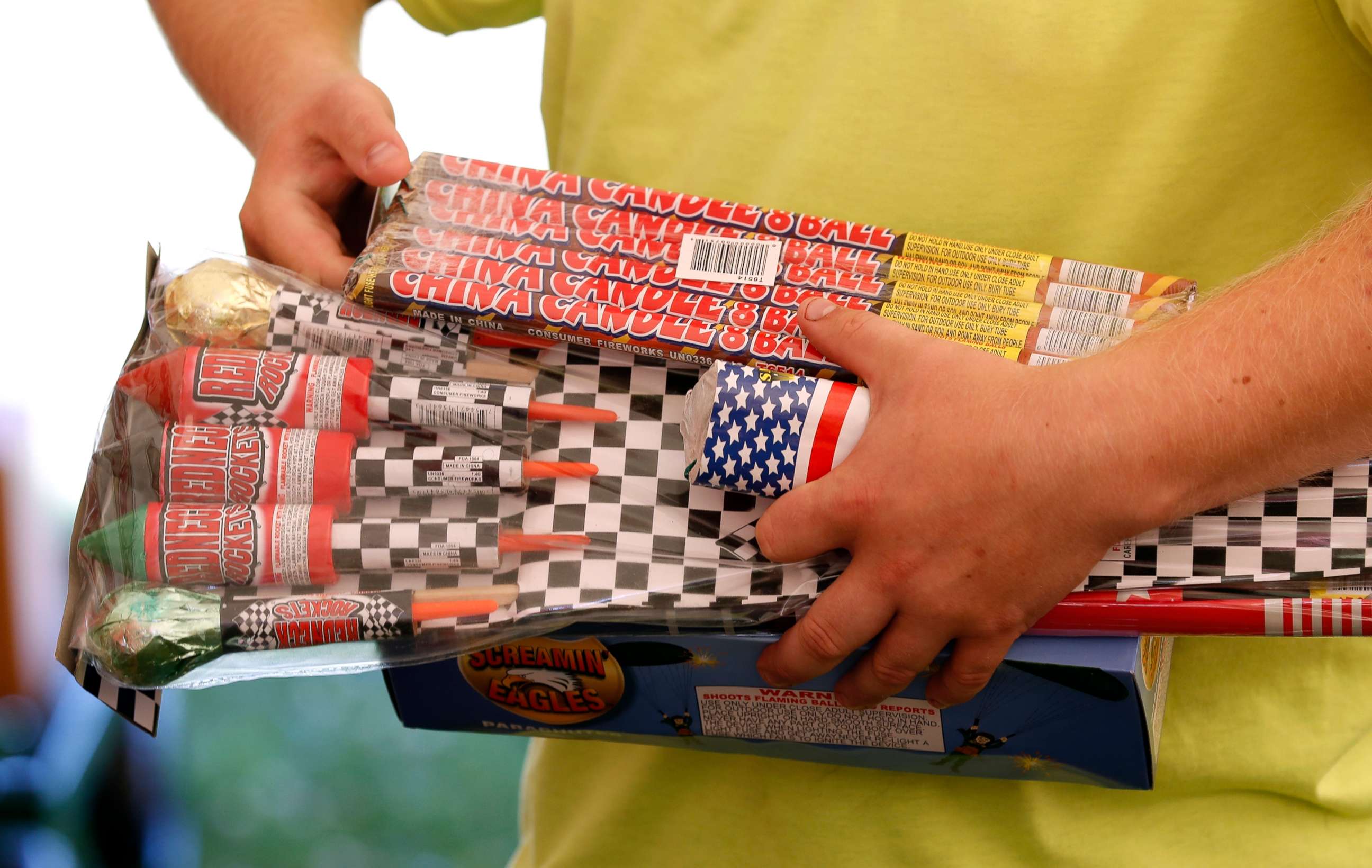 PHOTO: In this file photo, Julian Gibson holds packages of fireworks before buying them in a tent owned by the Iowa Fireworks Company, in Adel, Iowa, June 16, 2017.