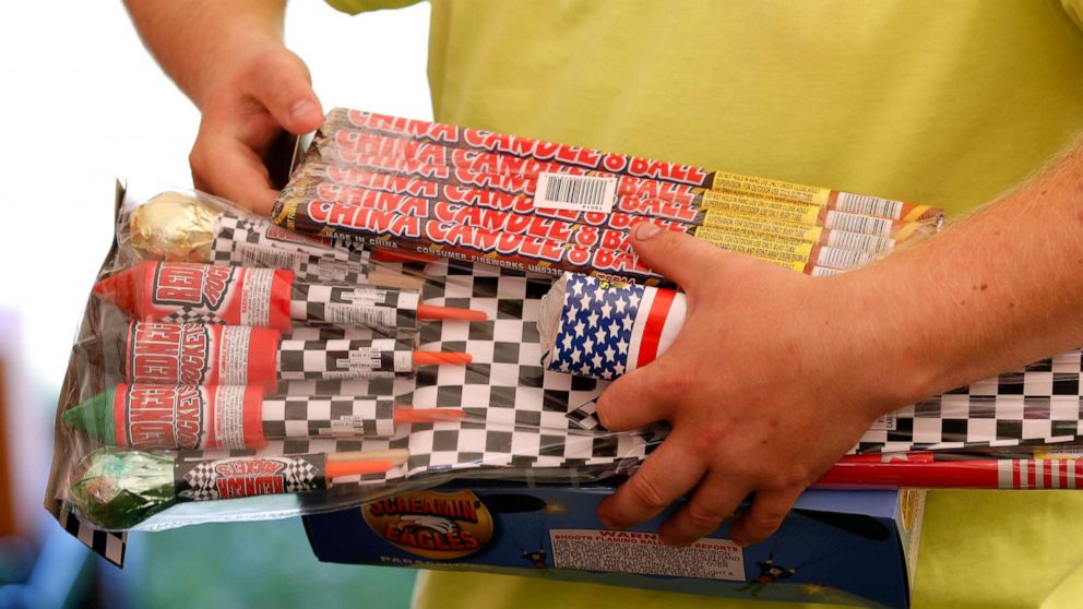 PHOTO: In this file photo, Julian Gibson holds packages of fireworks before buying them in a tent owned by the Iowa Fireworks Company, in Adel, Iowa, June 16, 2017.