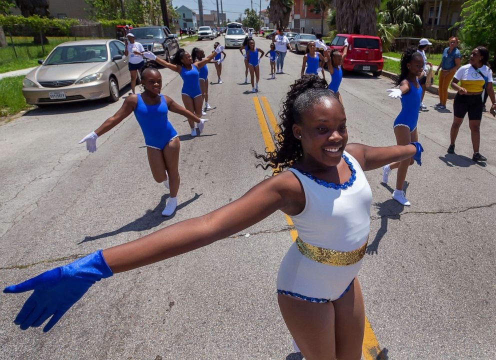 PHOTO: In this June 19, 2019, file photo, Leah Jones leads the Texas Dancin' Divas dance team down Ball Avenue during the annual Juneteenth Parade in Galveston, Texas.