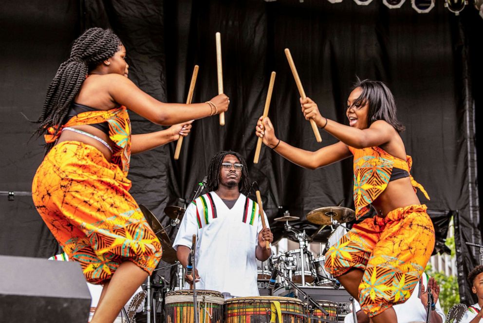 PHOTO: Members of the Sankofa Dance & Drum Team, Aysiah-Imani Miller, left, and Johnna Mullen, right, perform at Point State Park for the Western Pennsylvania Juneteenth Celebration on June 18, 2021, in Pittsburgh, Pa.