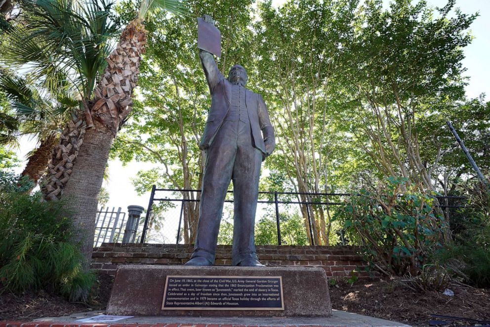 PHOTO: In this June 17, 2020, photo, a statue depicts a man holding the state law that made Juneteenth a state holiday in Galveston, Texas.
