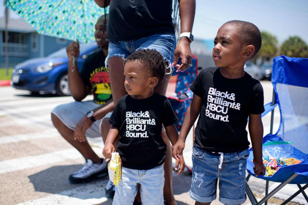 PHOTO: Two boys and their family celebrate during a Juneteenth parade in Galveston, Texas, on June 19, 2021.