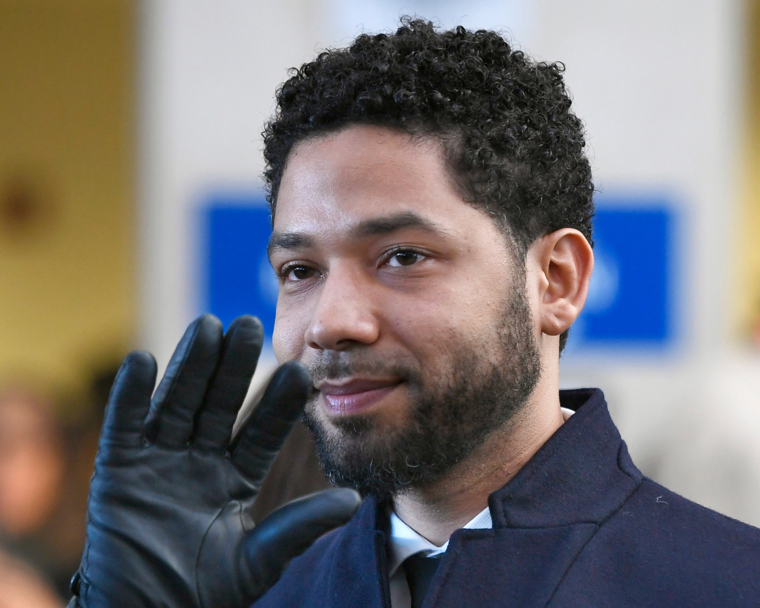 PHOTO: In this March 26, 2019, file photo, Actor Jussie Smollett smiles and waves to supporters before leaving Cook County Court after his charges were dropped in Chicago.