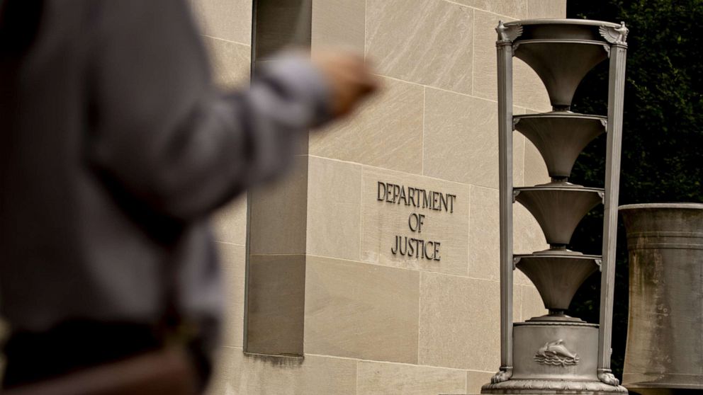 PHOTO: A pedestrian walks past the Department of Justice (DOJ) headquarters in Washington, D.C., Aug. 15, 2019.