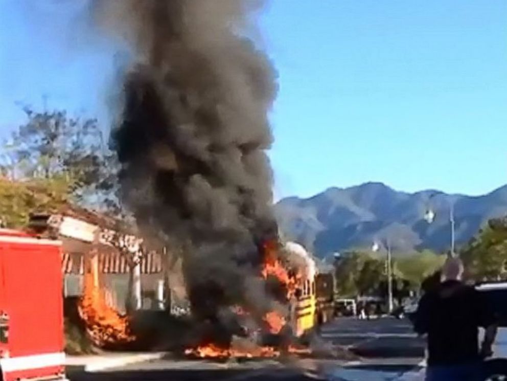 PHOTO: In this still, a school bus that caught fire is pictured outside Rancho Santa Margarita Intermediate School in Rancho Santa Margarita, Calif., March 27, 2015.