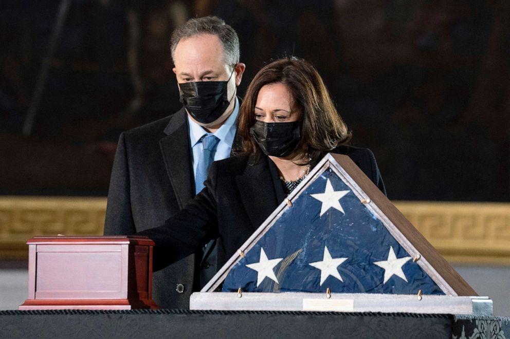 PHOTO: Vice President Kamala Harris and her husband Doug Emhoff pay their respects to U.S. Capitol Police officer Brian Sicknick as his remains lies in honor on a black-draped table at the center of the Capitol Rotunda, Feb. 3, 2021, in Washington, D.C.