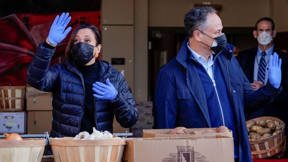 PHOTO: Vice President-elect Kamala Harris and her husband Doug Emhoff wave as they volunteer at Martha's Table on Martin Luther King Day in Washington, D.C., Jan. 18, 2021.