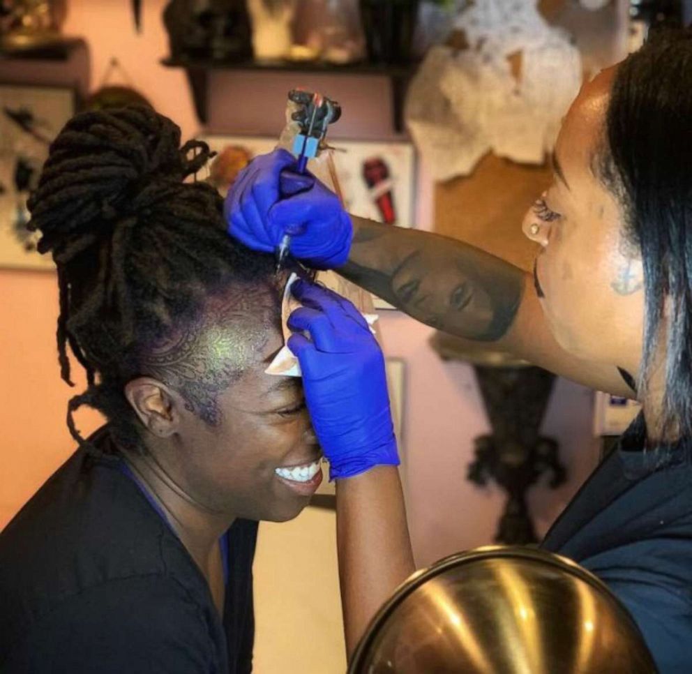 PHOTO: Kandace Layne, founder of Magic Mirror Tattoo Studio in Atlanta, tattoos a client in August 2019.
