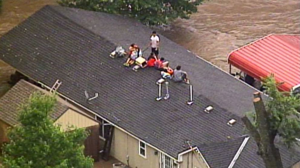 PHOTO: This aerial photo from a video by KCTV5 shows a family forced onto the roof of a home in Overland Park, Kan., Aug. 22, 2017, after heavy rains caused flash flooding in the Kansas City area.  Flash flood warnings have been issued across the area.