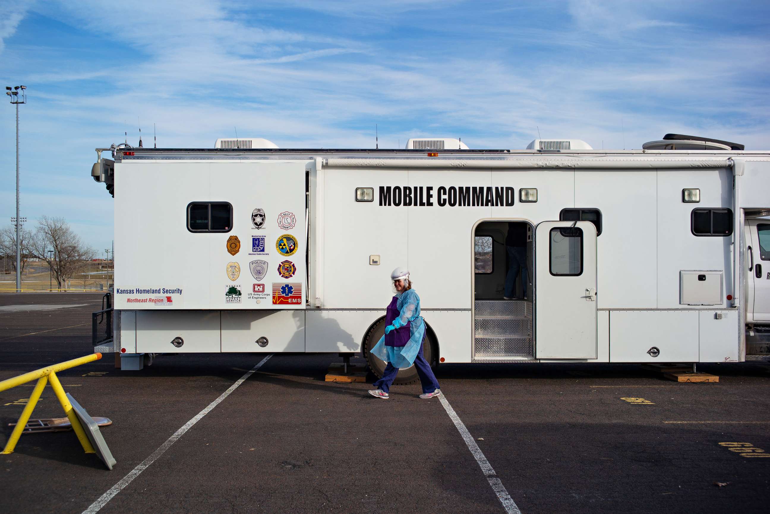 PHOTO: A nurse with the Riley County Health Department walks past the COVID-19 vaccine mobile command center in the parking lot of Bill Snyder Family Stadium at Kansas State University in Manhattan, Kansas, Dec. 22, 2010.