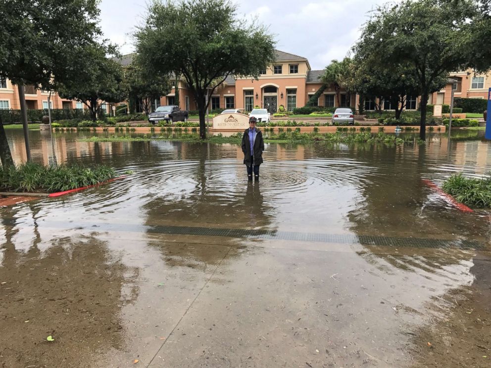 PHOTO: Freelance journalist Karen D'Uva stands in floodwaters from Hurricane Harvey outside the Gables Metropolitan Uptown apartments in Houston, Aug. 27, 2017.