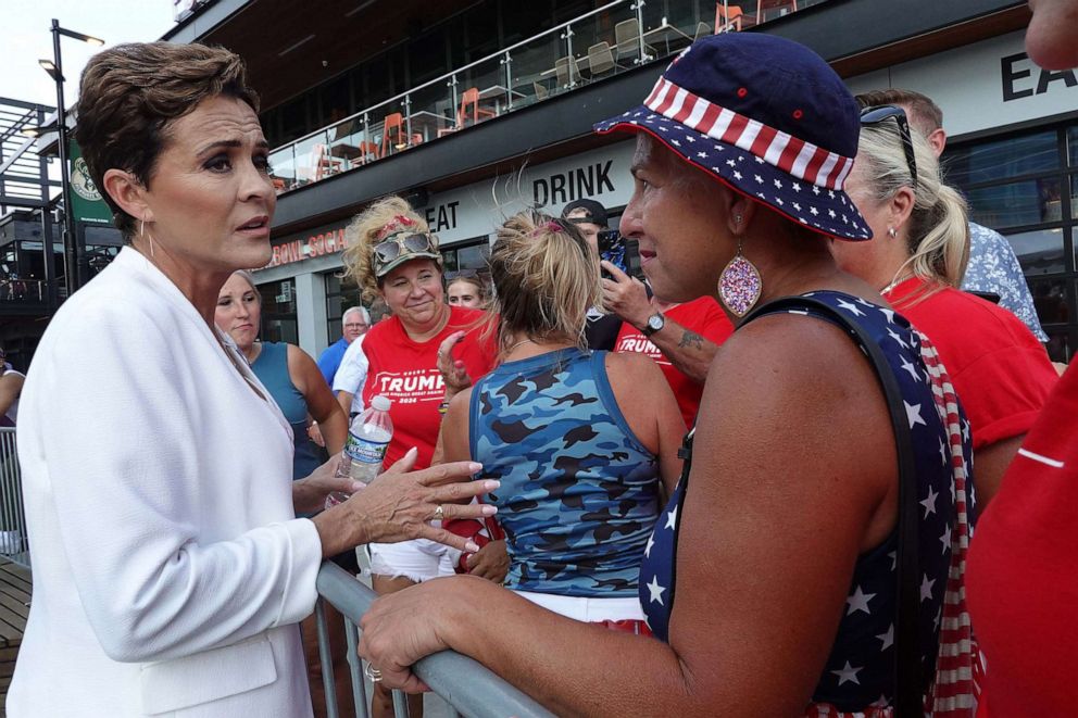 PHOTO: Former Arizona gubernatorial candidate and supporter of former President Donald Trump Kari Lake greets Trump supporters outside of the Fiserv Forum before the start of the first GOP presidential debate on Aug. 23, 2023. in Milwaukee, Wisconsin.