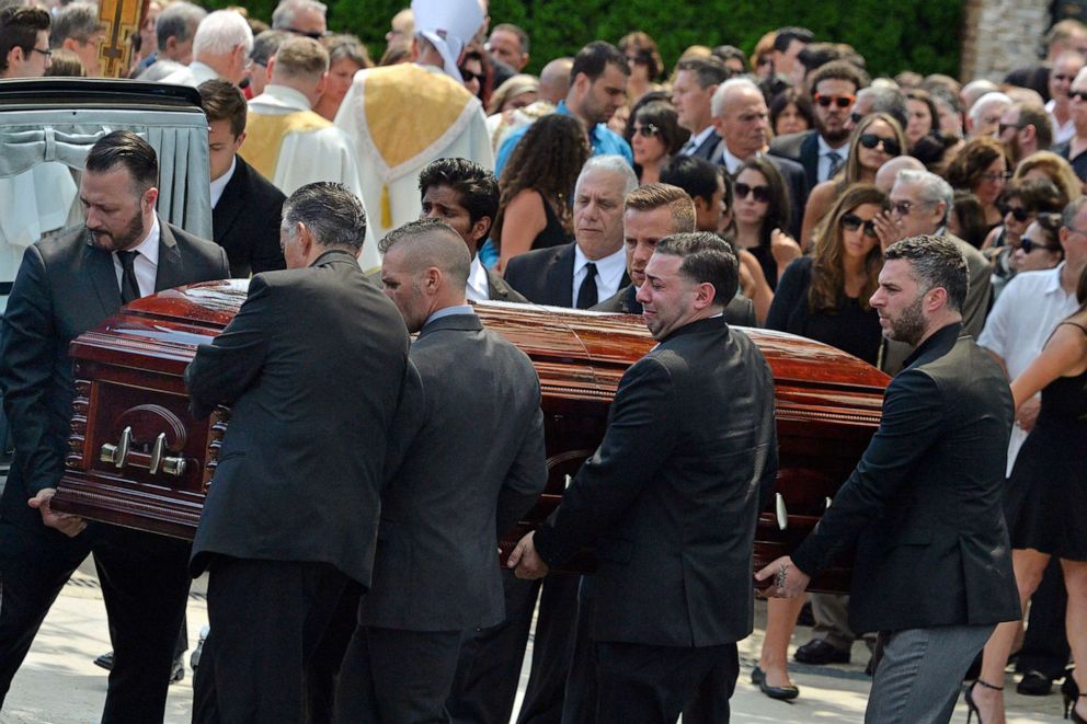 The mourners carry the coffin of Karina Vetrano from St. Helen's Church after her funeral in the Howard Beach section of Queens, New York on August 6, 2016.