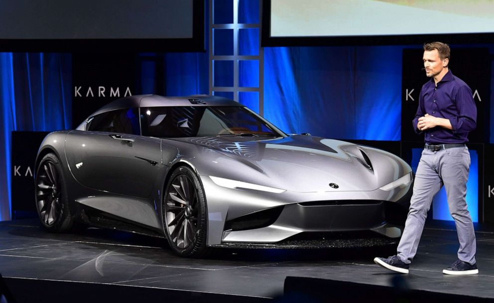 PHOTO: Andreas Thurner, Karma's VP of global design and architecture, walks beside the just unveiled Karma SC2 vehicle at the Automobility LA Technology Pavilion on November 19, 2019 in Los Angeles.