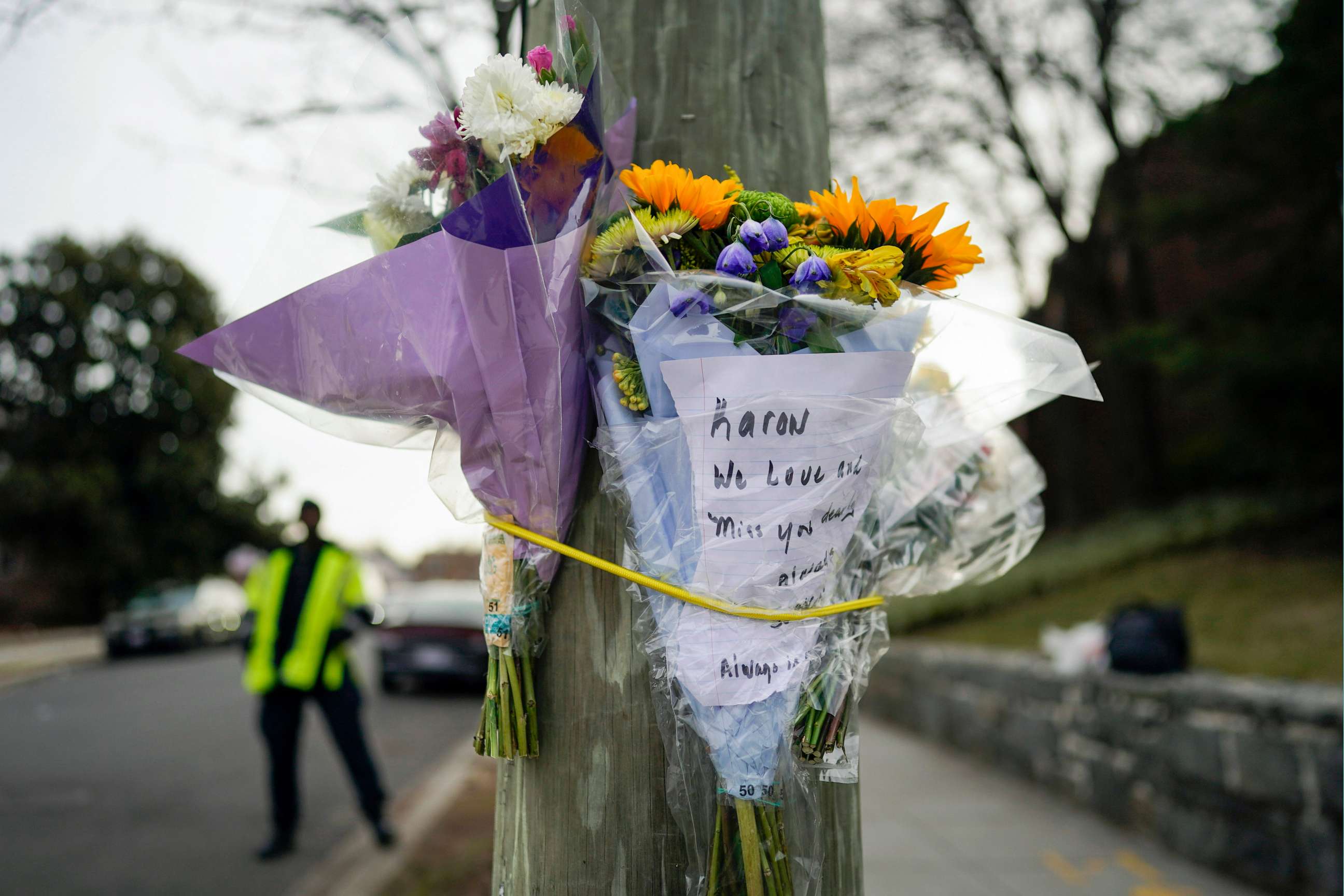 PHOTO: Flowers are secured to a pole as a memorial to Karon Blake, 13, on the corner of Quincy Street NE and Michigan Avenue NE in the Brookland neighborhood of Washington, Jan. 10, 2023. The note reads, "Karon we will love and miss you dearly."