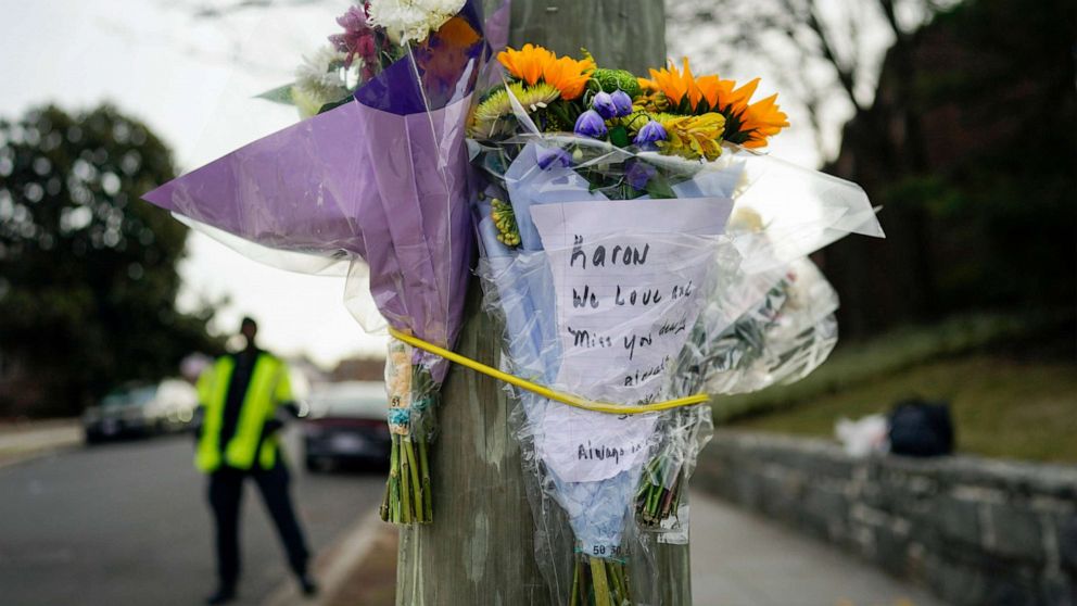 PHOTO: Flowers are secured to a pole as a memorial to Karon Blake, 13, on the corner of Quincy Street NE and Michigan Avenue NE in the Brookland neighborhood of Washington, Jan. 10, 2023. The note reads, "Karon we will love and miss you dearly."