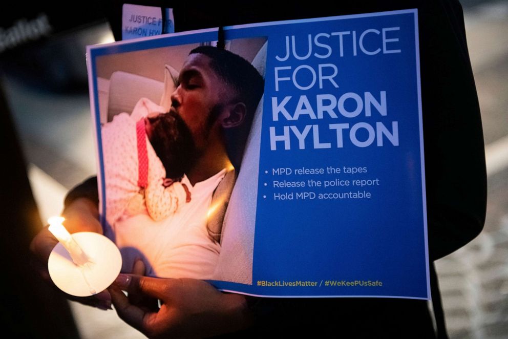 PHOTO: In this Oct. 28, 2020, file photo, a protester holds a sign and candle during a vigil in memory of Karon Hylton who was killed last week in a traffic collision after leaving a police traffic stop.