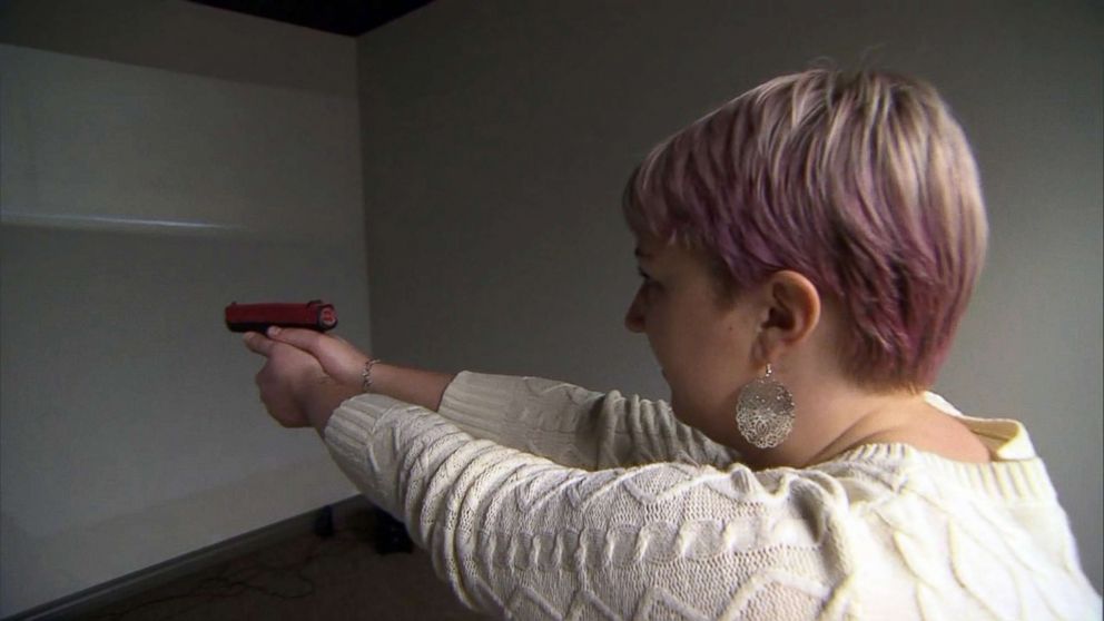 PHOTO: Kasey Hansen, a special education teacher in Utah, is seen here practicing at a gun range with a video simulation.