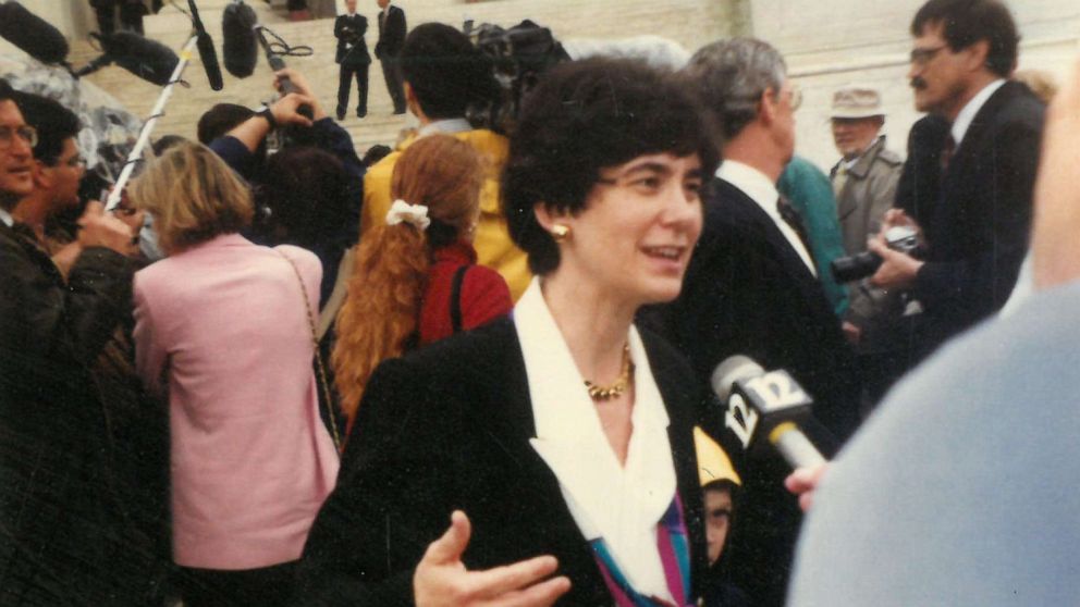 PHOTO: Kathryn Kolbert speaks to the press on the steps of the Supreme Court immediately following her argument in Planned Parenthood v. Casey while her son Sam peers out from behind her in Washington, April 1992.