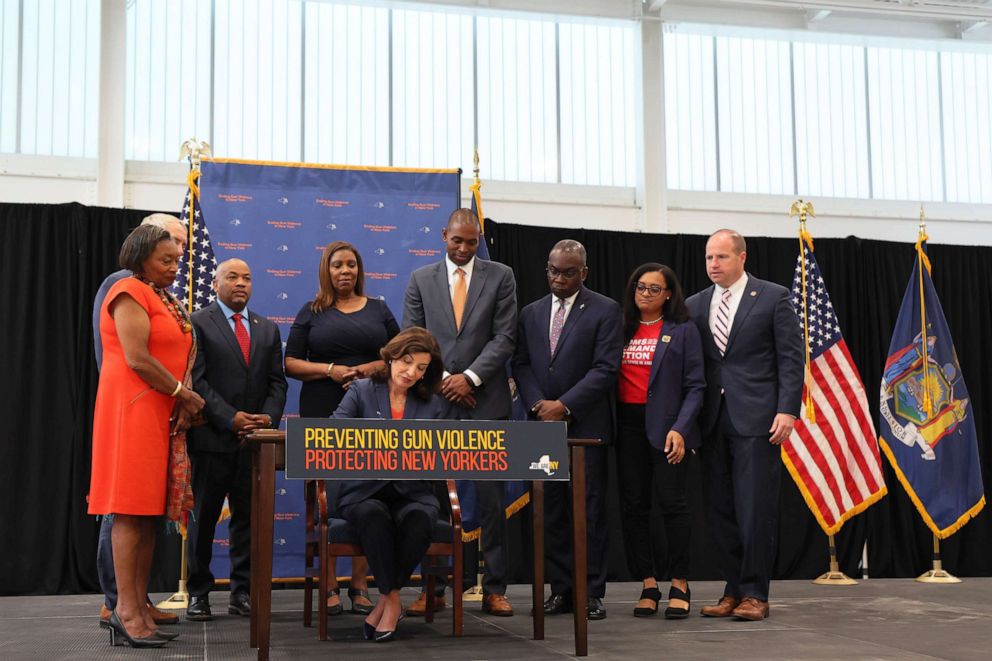 PHOTO: NEW YORK, NEW YORK - JUNE 06: Gov. Kathy Hochul signs legislation as she is surrounded by lawmakers during a bill signing ceremony at the Northeast Bronx YMCA on June 06, 2022 in New York City. 