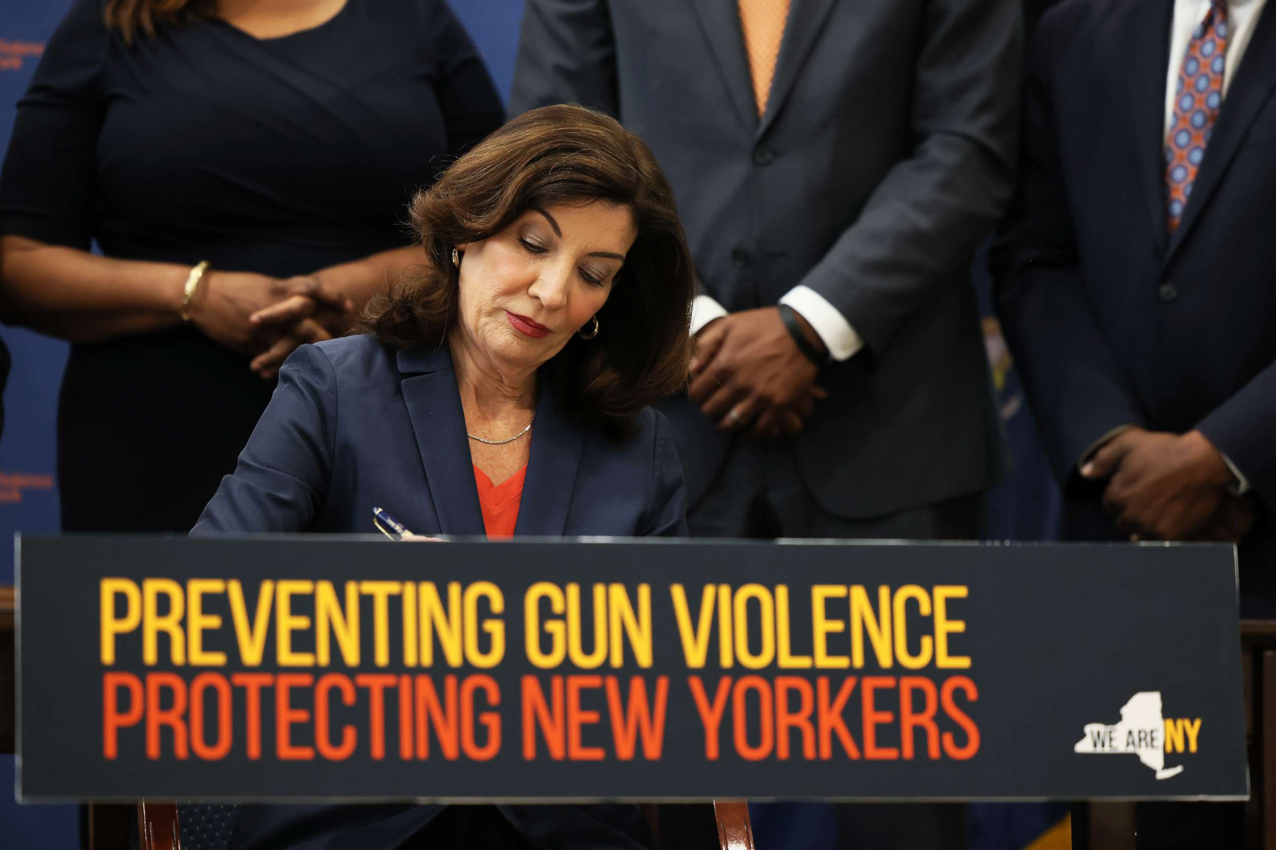 PHOTO: NEW YORK, NEW YORK - JUNE 06: Gov. Kathy Hochul signs legislation as she is surrounded by lawmakers during a bill signing ceremony at the Northeast Bronx YMCA on June 06, 2022 in New York City. 