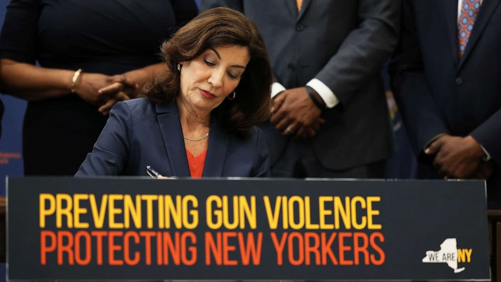 PHOTO: NEW YORK, NEW YORK - JUNE 06: Gov. Kathy Hochul signs legislation as she is surrounded by lawmakers during a bill signing ceremony at the Northeast Bronx YMCA on June 06, 2022 in New York City. 