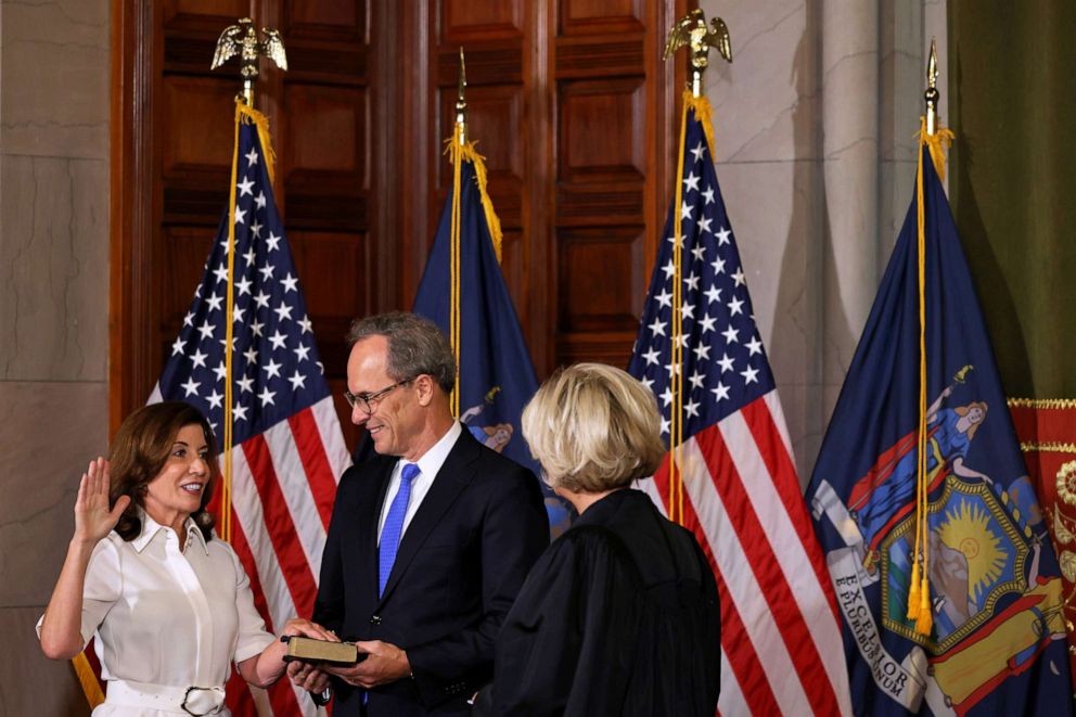 PHOTO: New York Gov. Kathy Hochul, accompanied by her husband William J. Hochul Jr., takes the ceremonial oath of office, administered by Chief Judge Janet DiFiore at the New York State Capitol, Aug. 24, 2021, in Albany, New York.