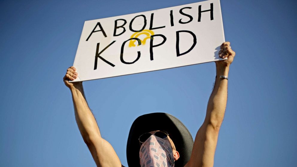 PHOTO: A demonstrator holds a sign calling for the disbanding of the Kansas City, Mo. Police Department during a rally in Kansas City, Mo., Saturday, June 13, 2020, to protest the death of George Floyd.