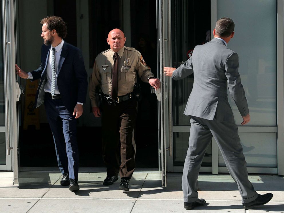 PHOTO: SSt. Louis County police Sgt. Keith Wildhaber, center, flanked by his attorneys Sam Moore, left, and Russell Riggan leave the St. Louis County justice center, Oct. 22, 2019, in Clayton, Mo.
