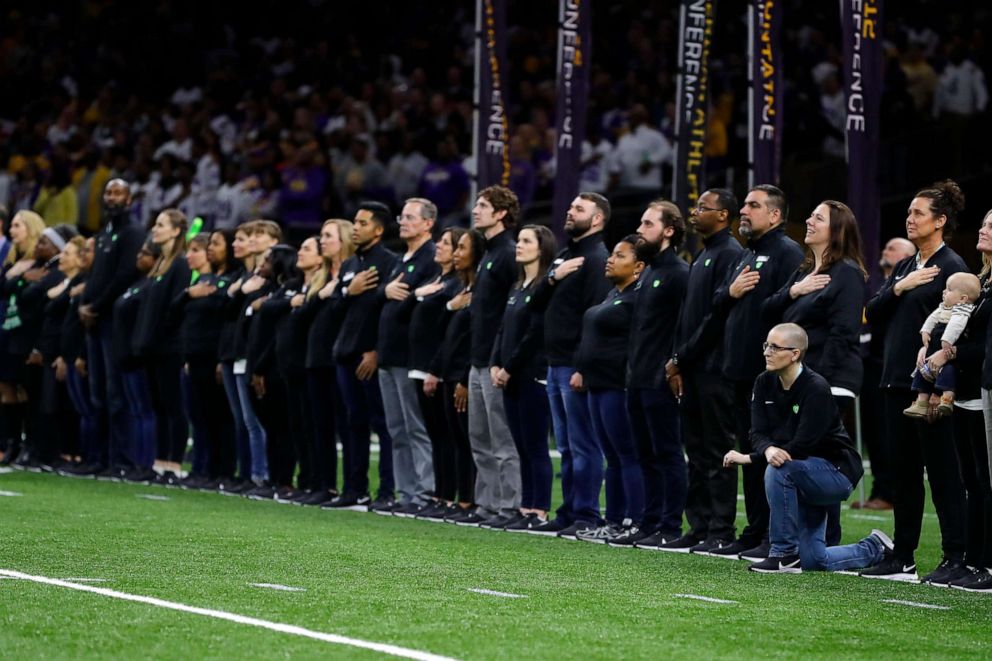 PHOTO: Minnesota's "Teacher of the Year," Kelly Holstine, kneels during the National Anthem prior to the College Football Playoff National Championship game at Mercedes Benz Superdome on Jan. 13, 2020 in New Orleans.