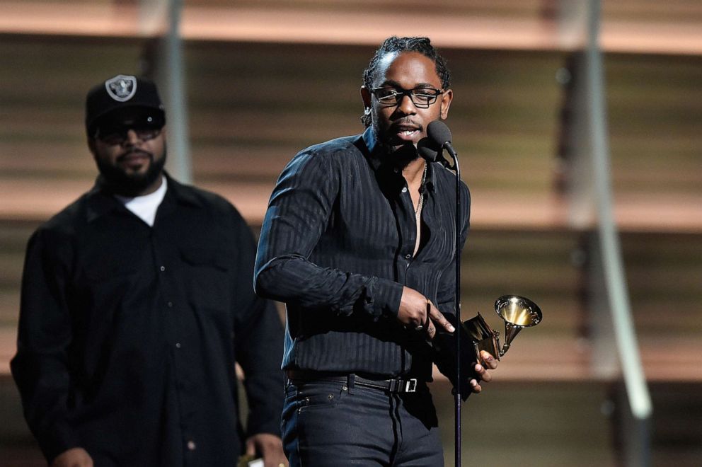 PHOTO: Rapper Kendrick Lamar accepts the award for Best Rap Album for "To Pimp a Butterfly" from rapper Ice Cube onstage during The 58th Grammy Awards at Staples Center on Feb. 15, 2016, in Los Angeles.