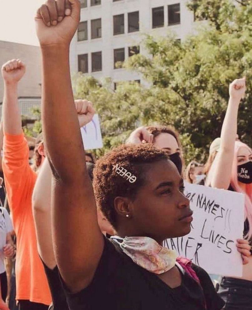 PHOTO: Activist Kenidra Woods raising a fist at a protest in Missouri.
