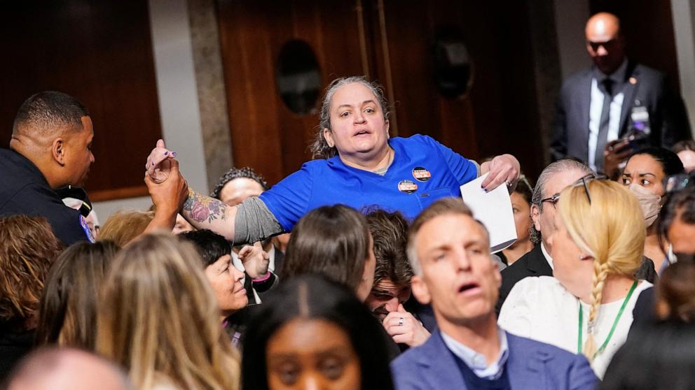 PHOTO: United States Capitol Police officer removes a protester, as Robert F. Kennedy Jr., President Trump's nominee to be Secretary of Health and Human Services, testifies at his confirmation hearing in Washington, Jan. 29, 2025. 