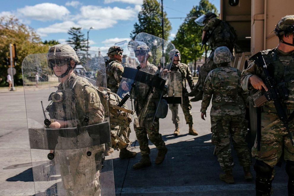 PHOTO: National Guard officers unload an armoured vehicle filled with soldiers outside of the Kenosha County Courthouse during a Blue Lives Matter rally organized by supporters of law enforcement officers.