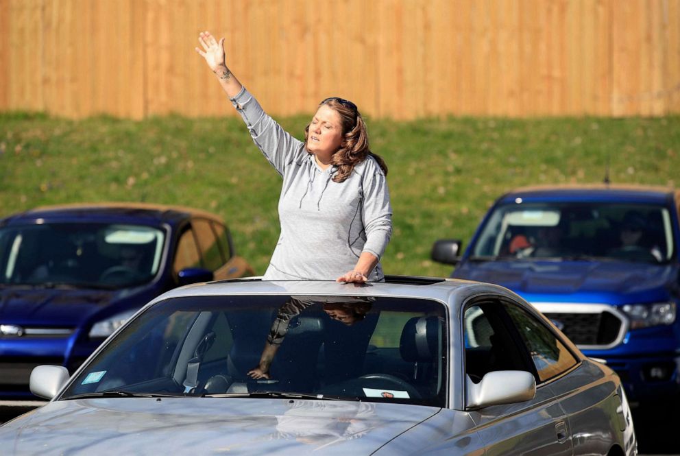 PHOTO: A worshiper listens to a song during the drive in service at On Fire Christian Church on April 5, 2020 in Louisville, Ky. 
