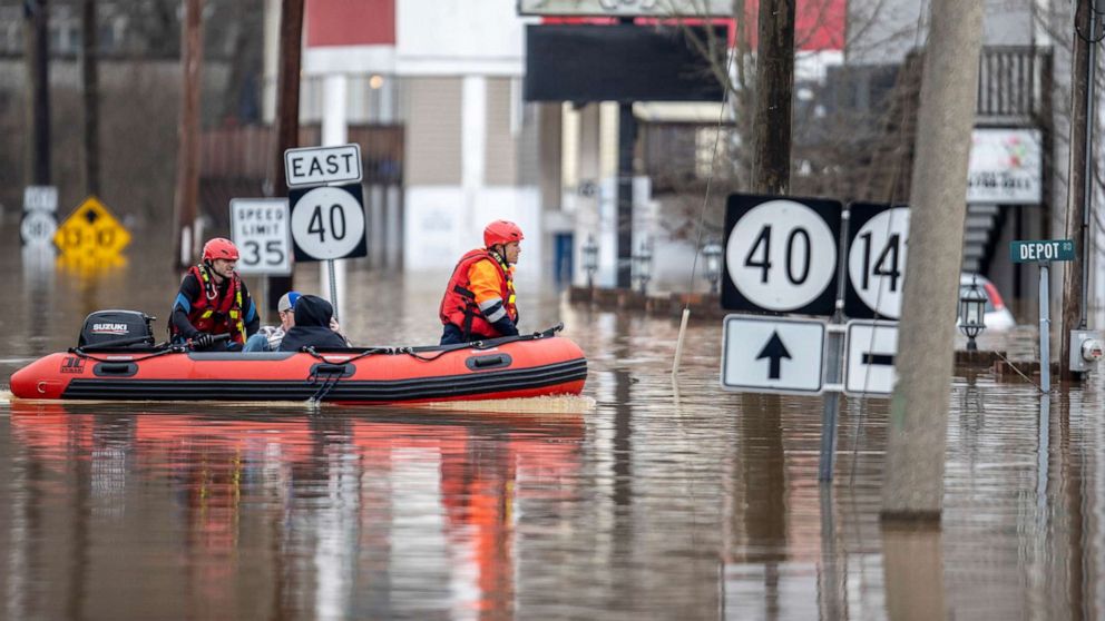 PHOTO: Ricky Keeton, left, of the Oil Springs Fire Department, and Michael Oiler, of the Thelma Fire Department, conduct a water rescue in Paintsville, Ky., March 1, 2021.
