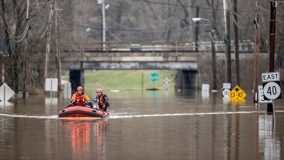PHOTO: Michael Oiler, left, of the Thelma Fire Department, and Ricky Keeton, of the Oil Springs Fire Department, conduct a water rescue in Paintsville, Ky., following heavy rain on March 1, 2021.