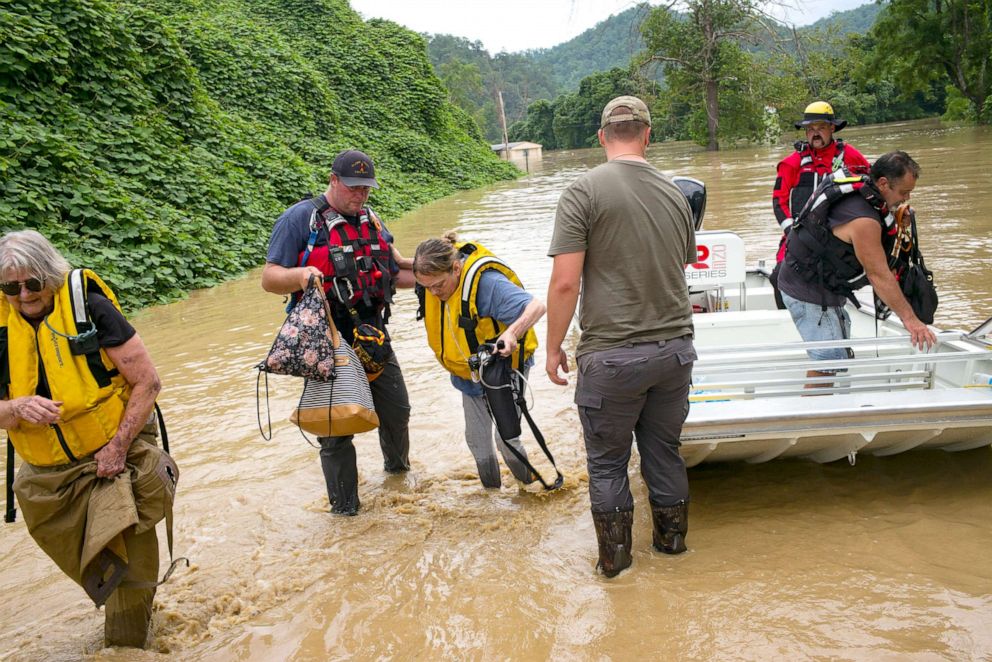PHOTO: Members of a rescue team assist a family out of a boat in Quicksand, Ky., on July 28, 2022. Storms have dropped as much as 12 inches of rain in some parts of Eastern Kentucky, causing devastating floods in some areas.