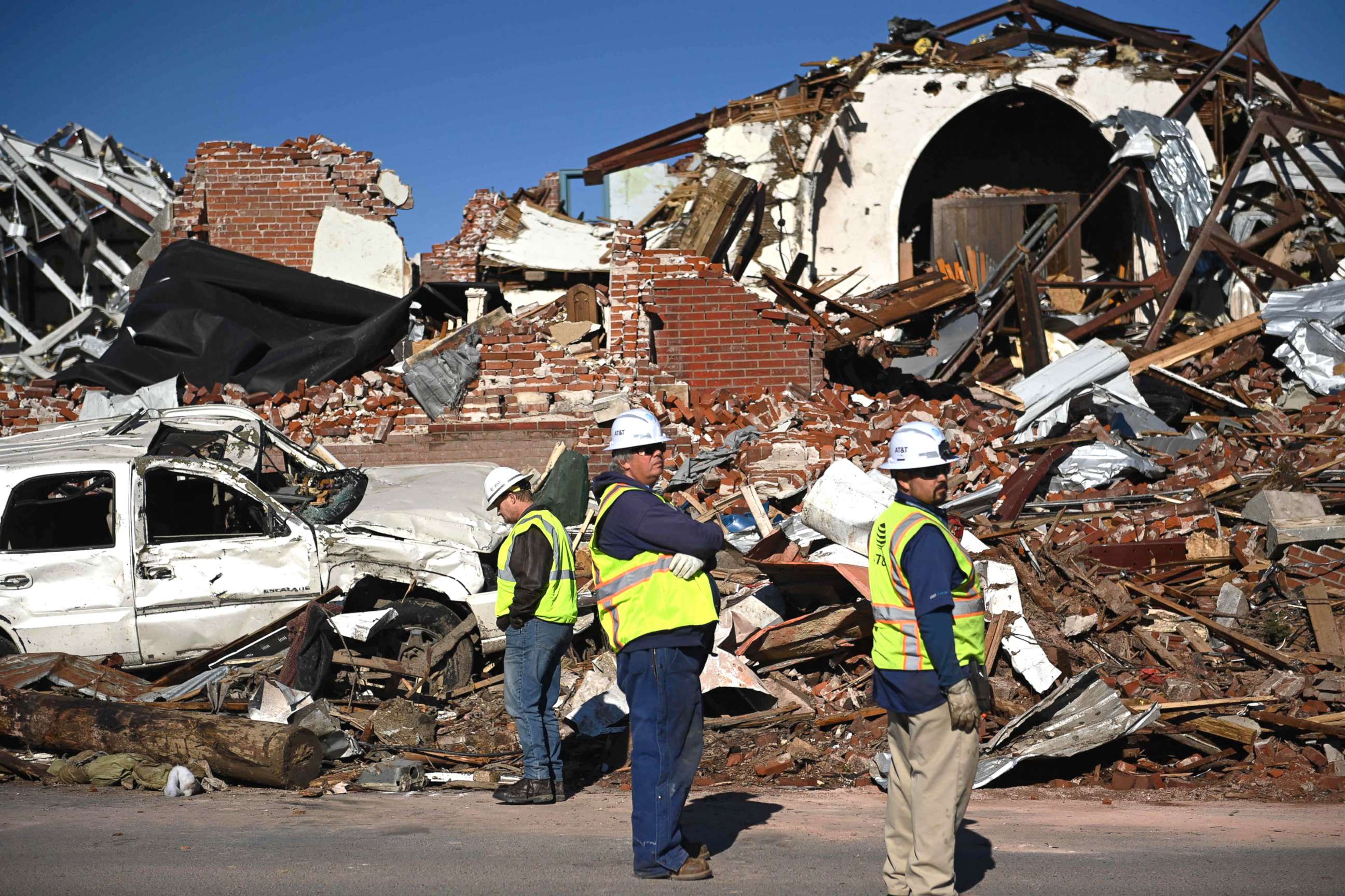 PHOTO: Workers survey tornado damage after extreme weather hit the region Dec. 12, 2021, in Mayfield, Ky.